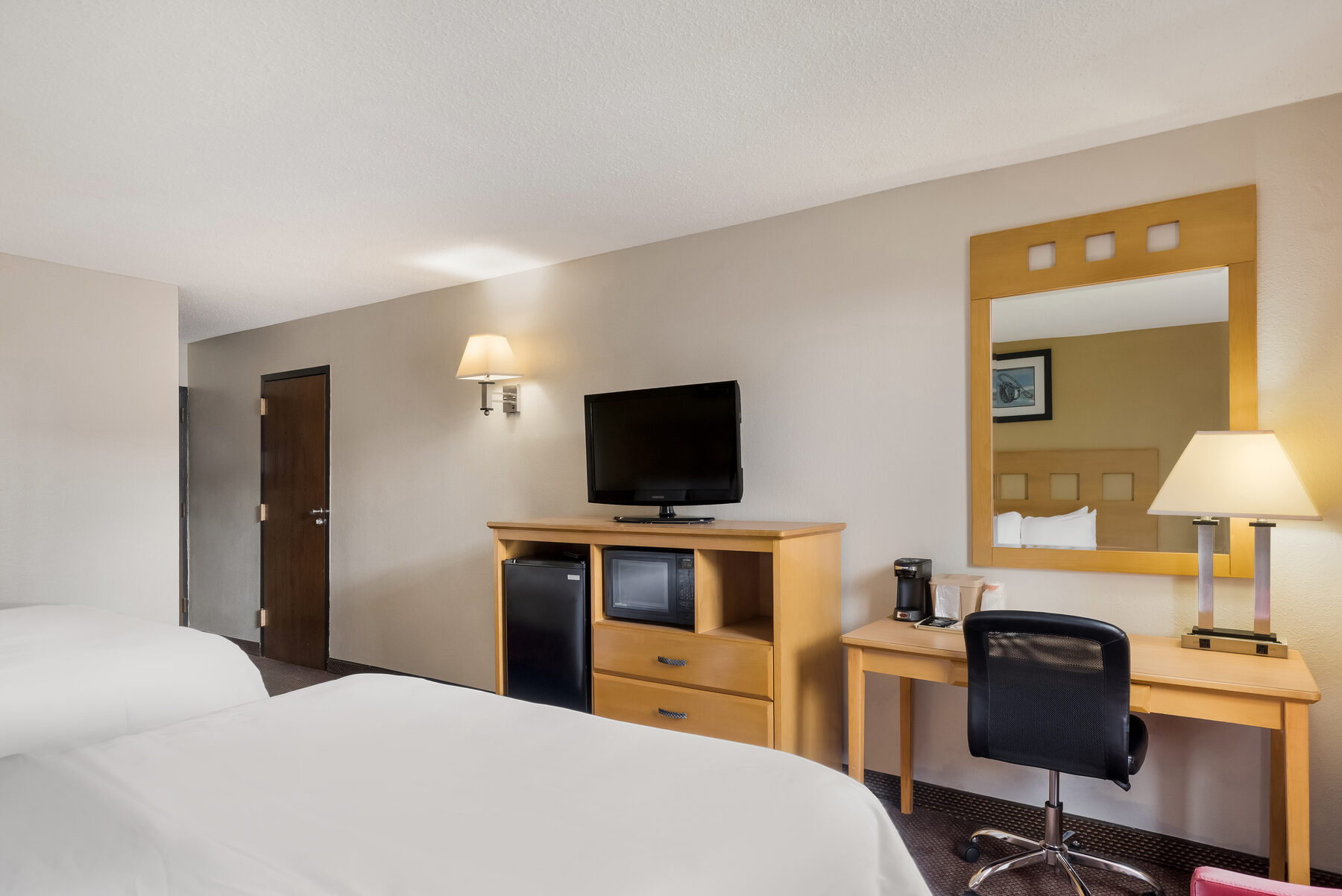 Room with two queen beds and western-style artwork